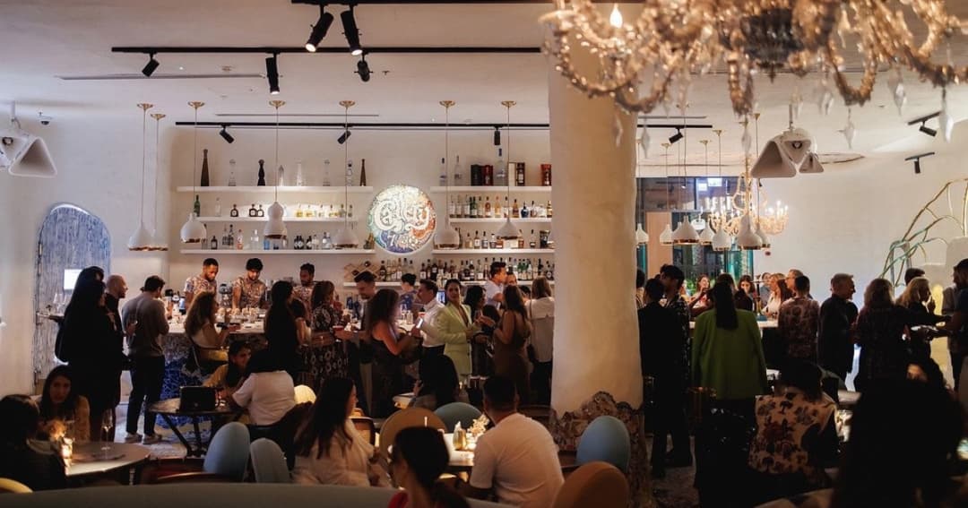 Group of people standing at a bar 