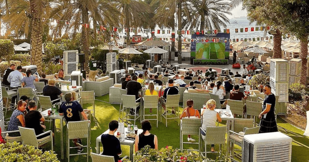 Guest watching a game of football at Wavebreaker's outside area.