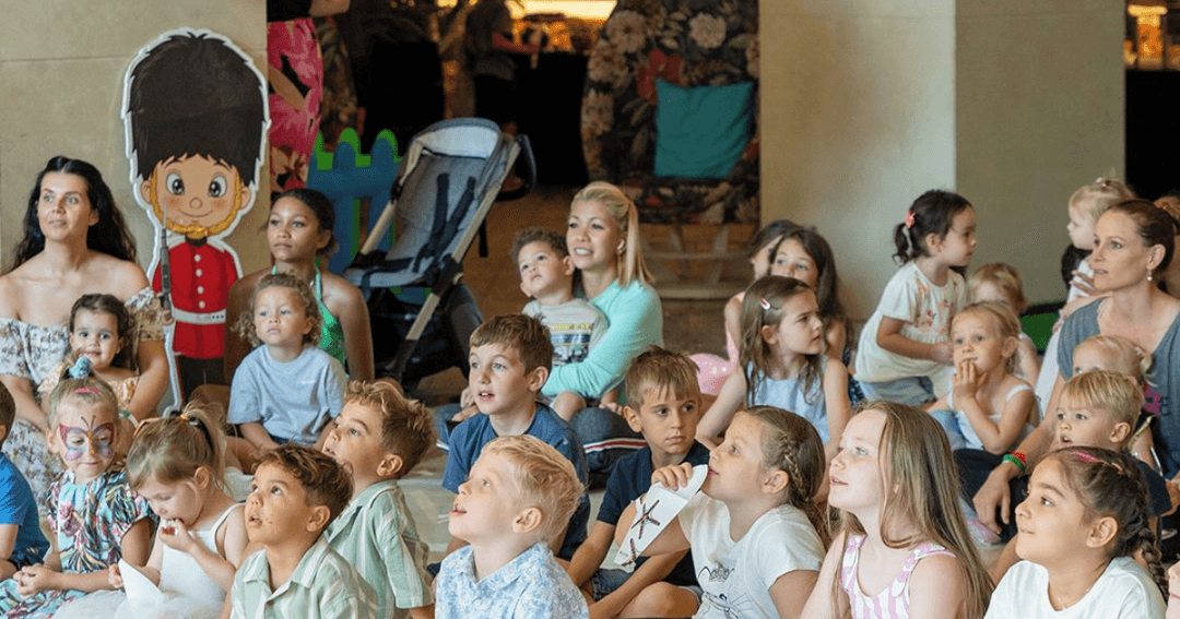 Kids enjoying live entertainment at Mina's Kitchen.