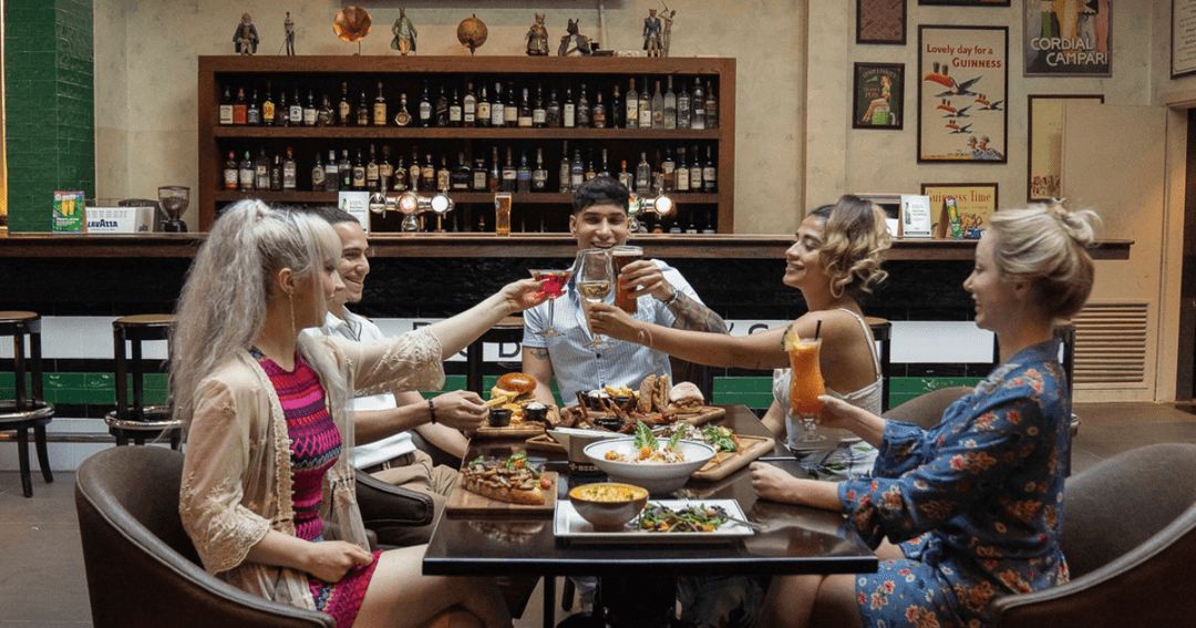 Group of friends raising a toast over a meal at The Dubliners