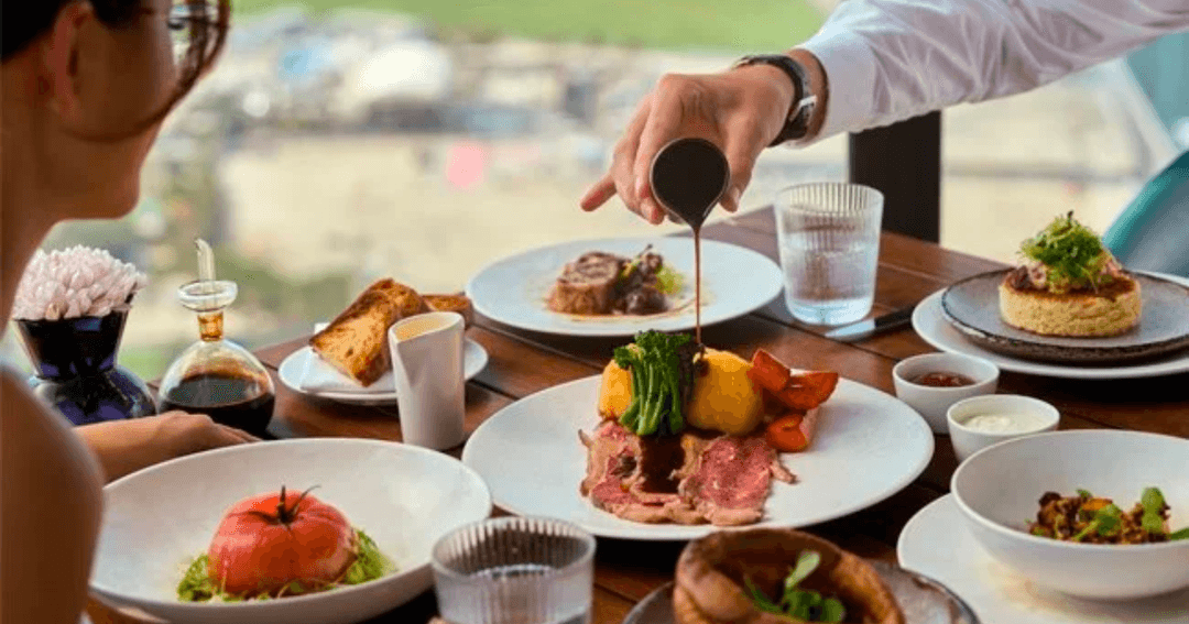 Waiter serving a woman with a Sunday Roast