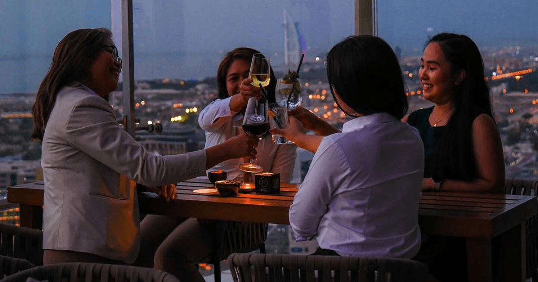 Four women toasting their drinks at Twenty Three