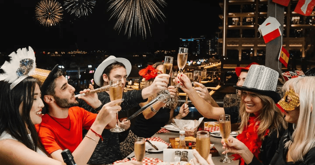 Guests toasting with fireworks in the background