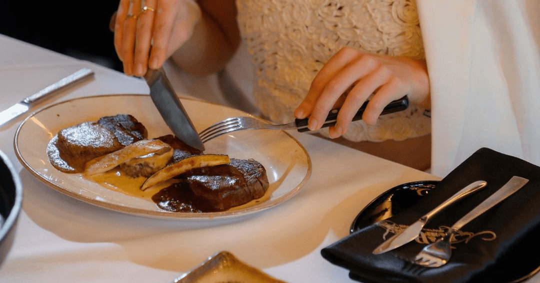 Guest enjoying a fine steak at Reef & Beef