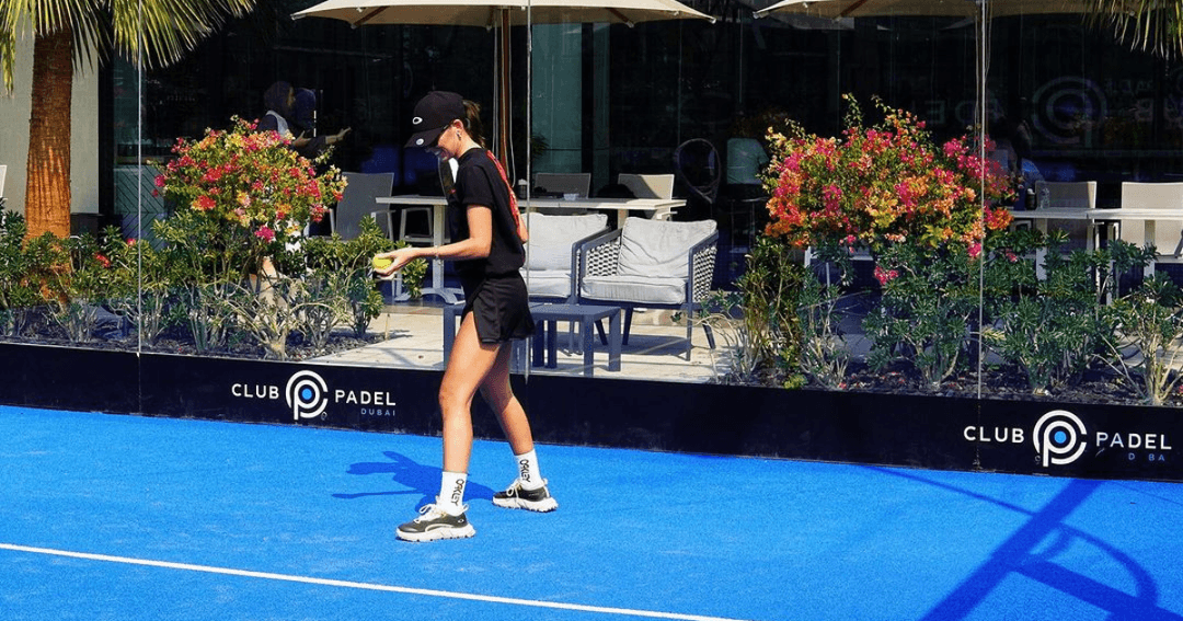 A lady playing padel tennis