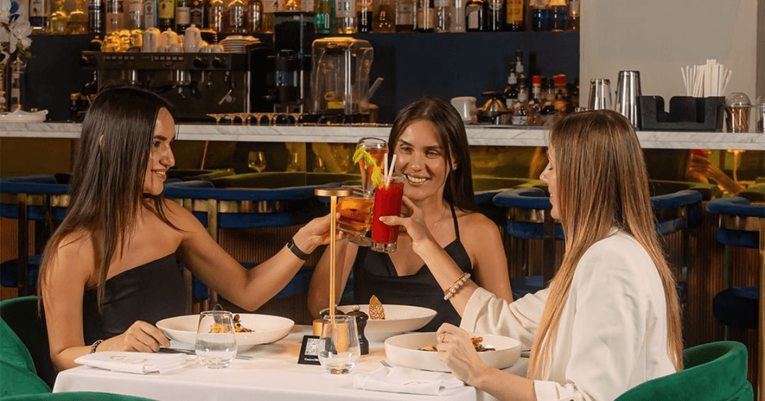 Three woman toasting their drinks