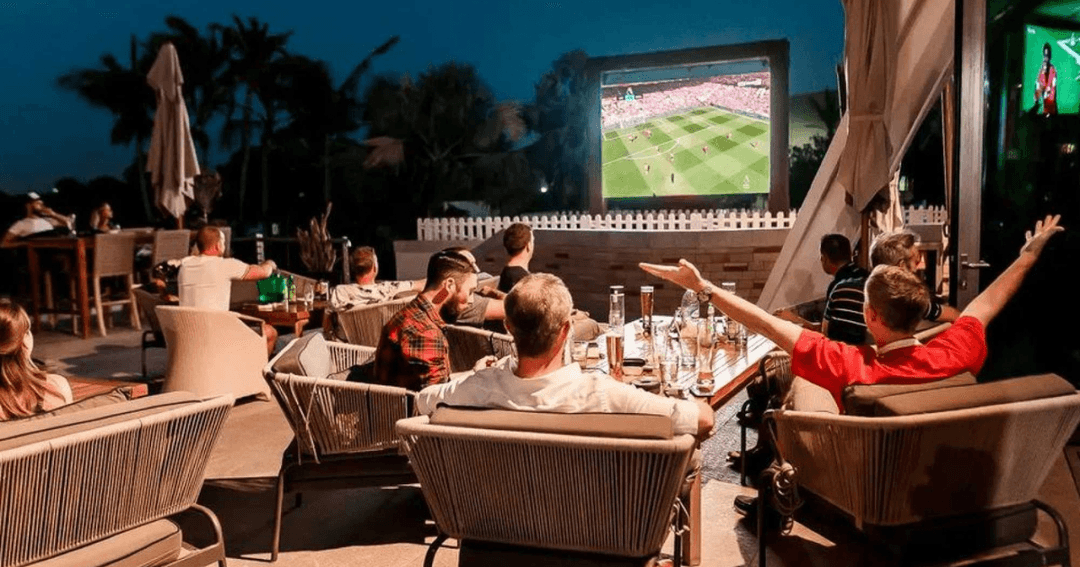 Guest watching live sports in the outside area at Spike Bar