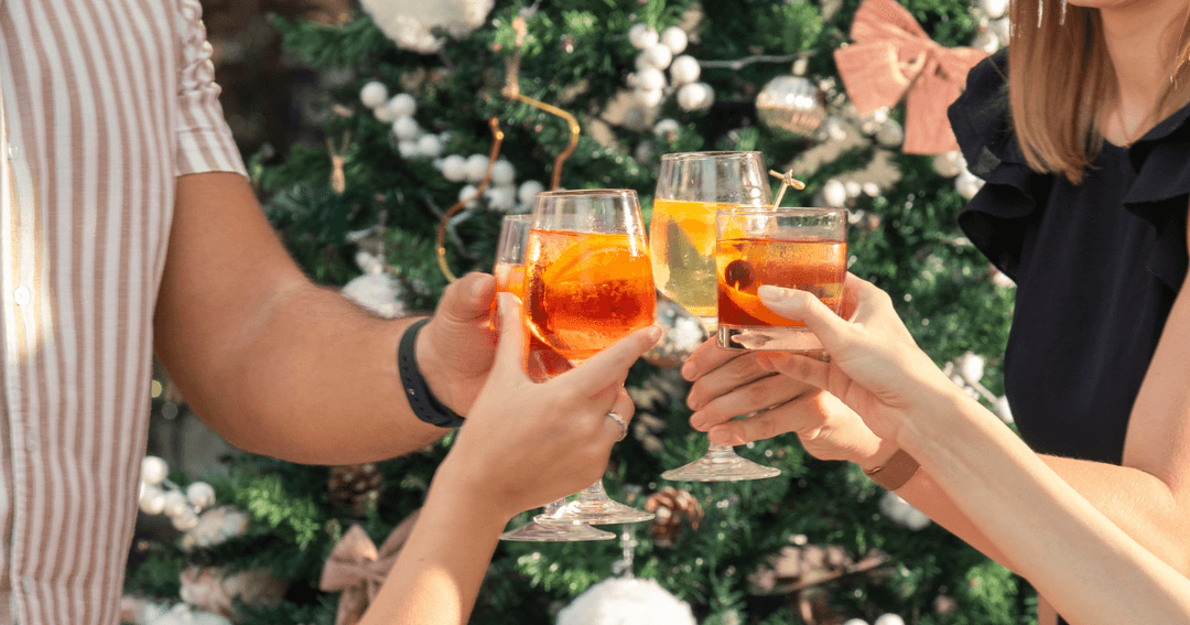 Guest toasting with a Christmas tree in the background 