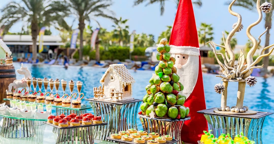 Desserts on a table with a pool in the background