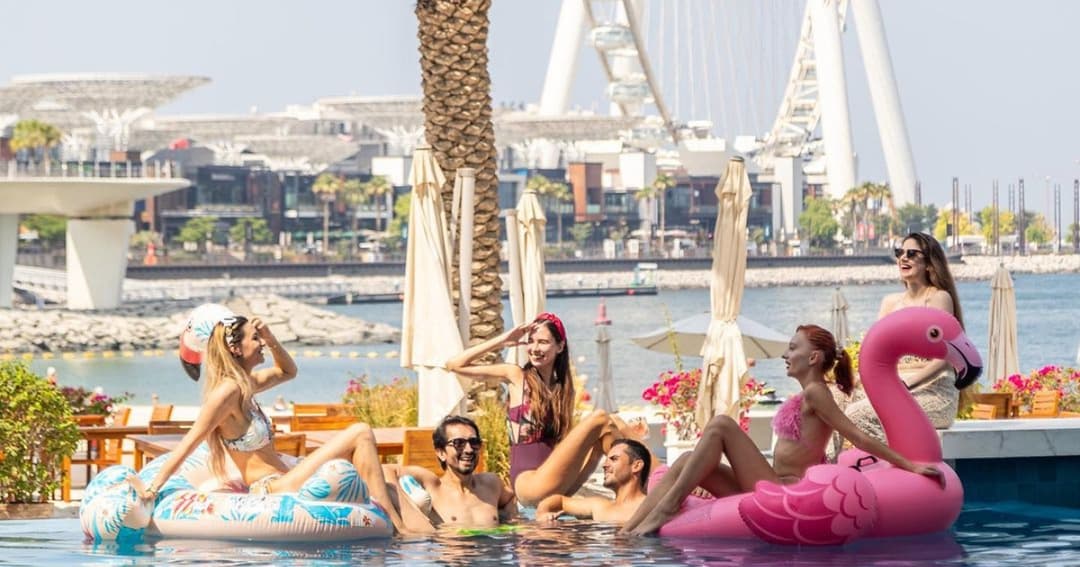 A group of friends relaxing in  pool