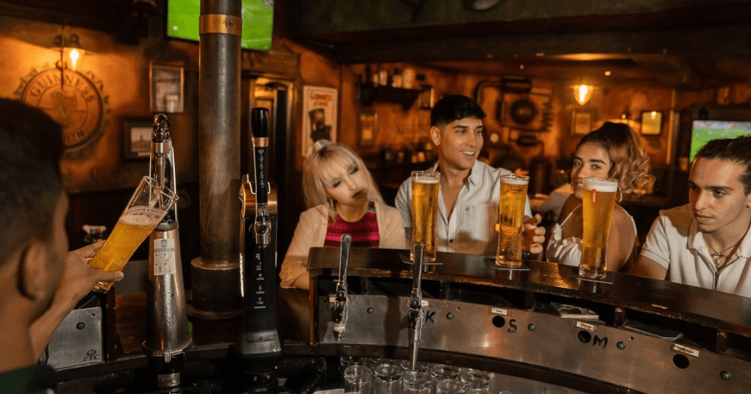 Four people sitting by the bar