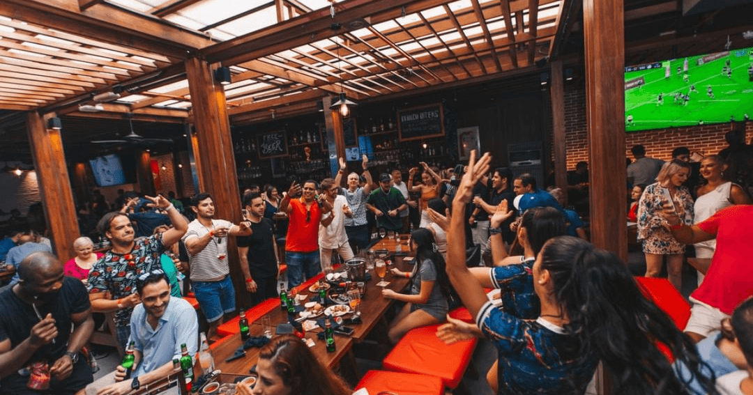 Guests cheering to a rugby match