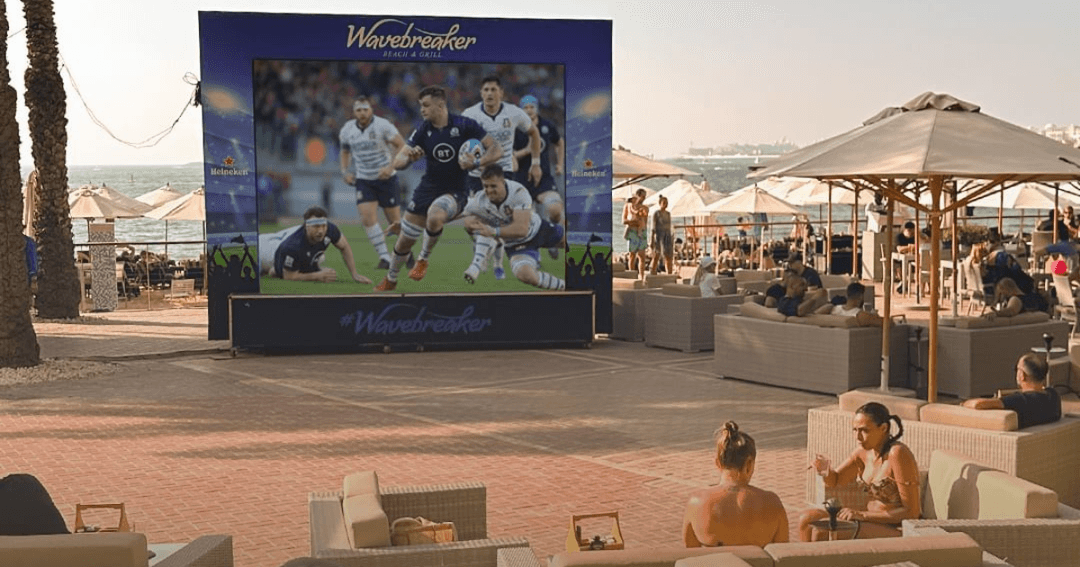 Big screen with live rugby