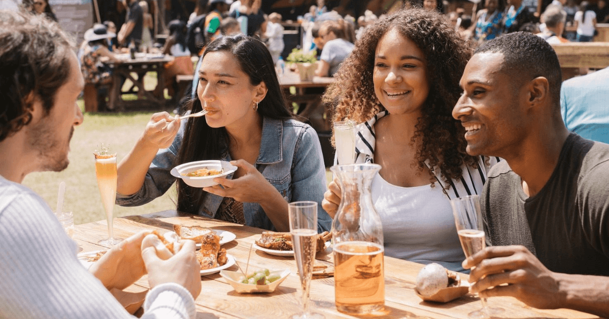 Group of friends eating together outdoors