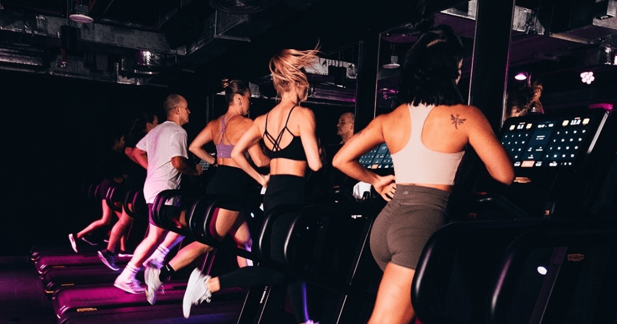 Group of people running on treadmills