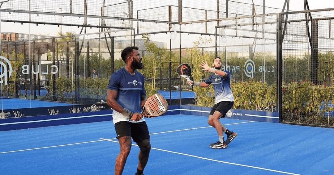 Two men playing padel at Club Padel