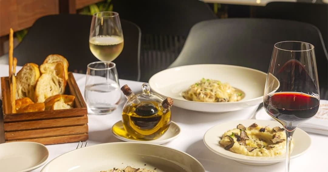 Pasta, wine and bread on the table