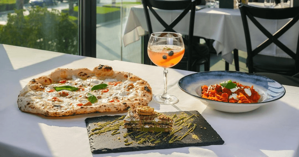 Pizza, pasta and wine on the table