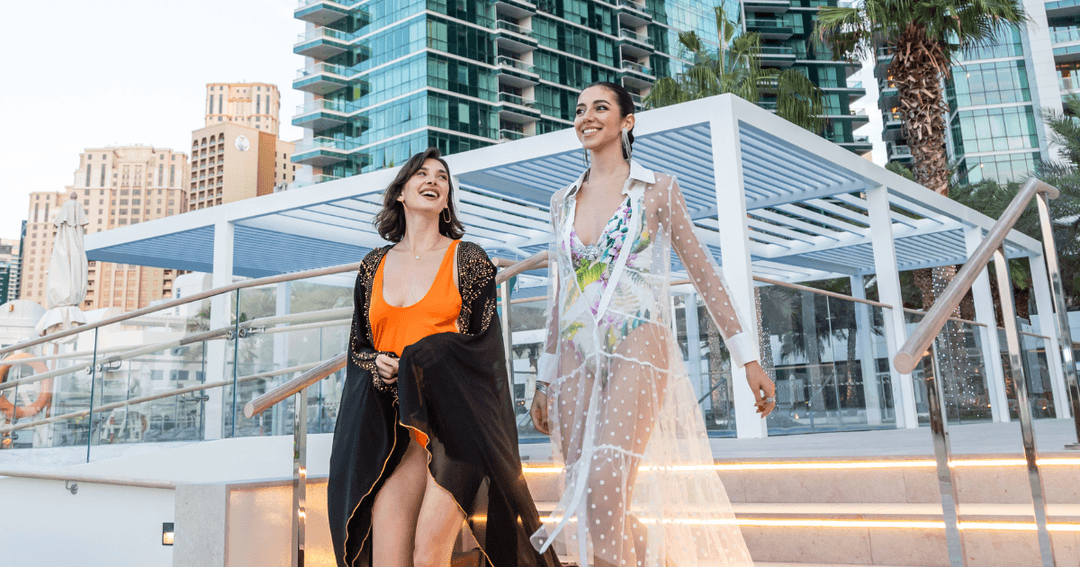 Two women enjoying walking towards a pool