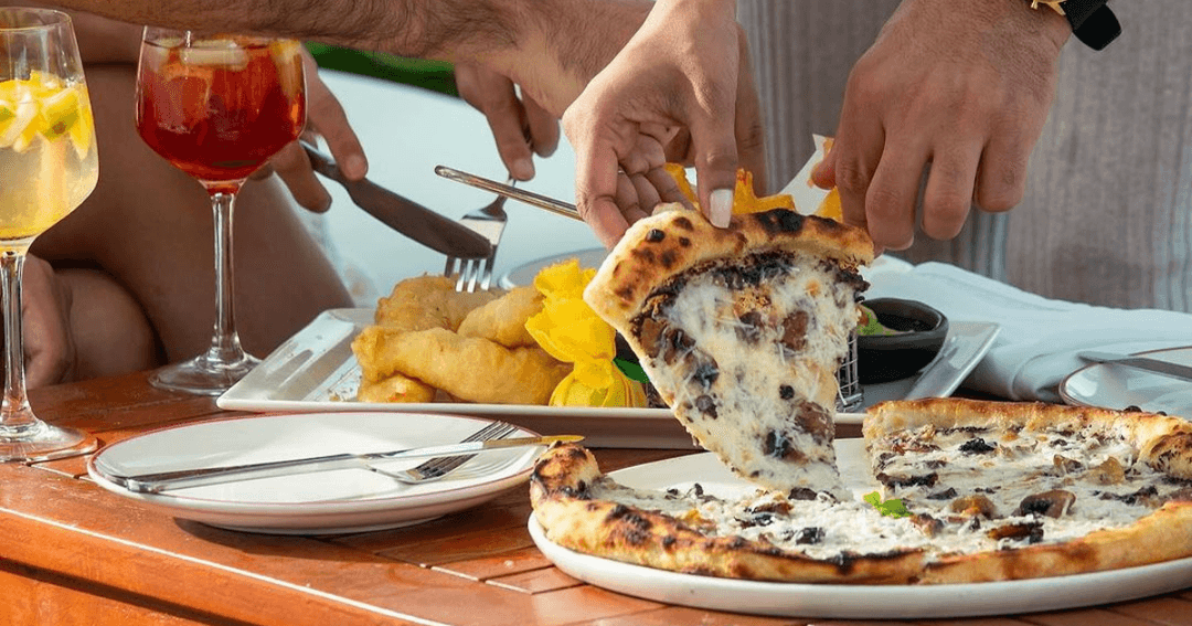 Pizza and drinks on a table