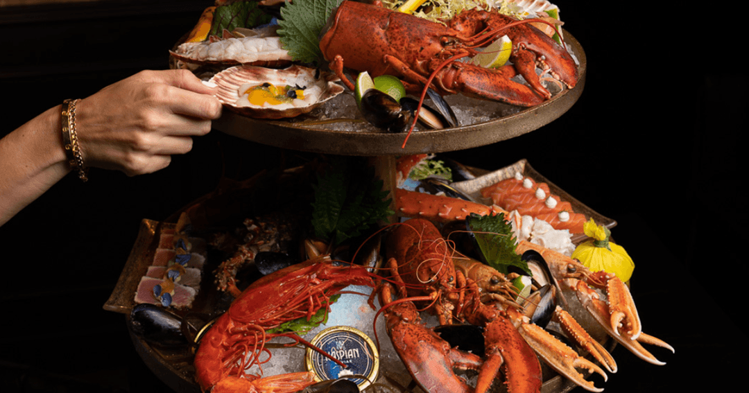 Guest taking a piece from a seafood tower