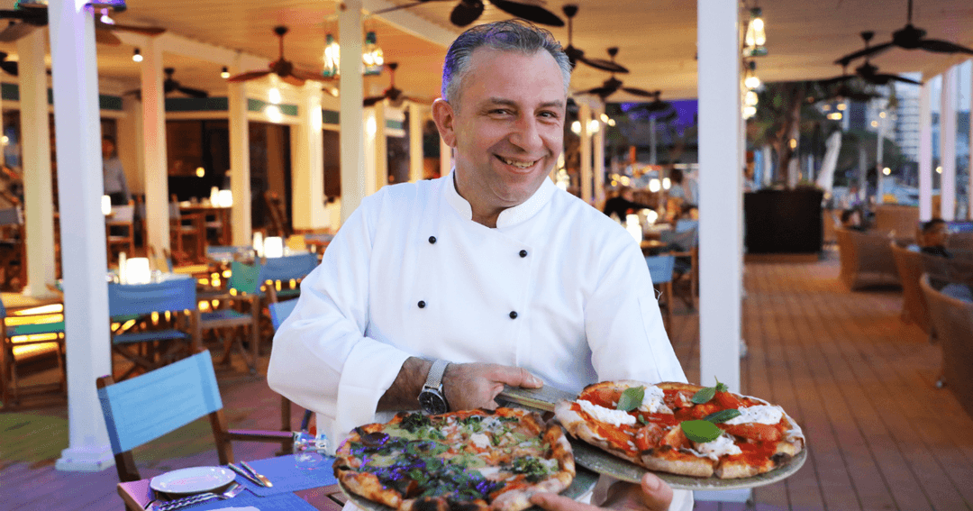 Chef Danilo Sangrigoli showcasing his pizzas