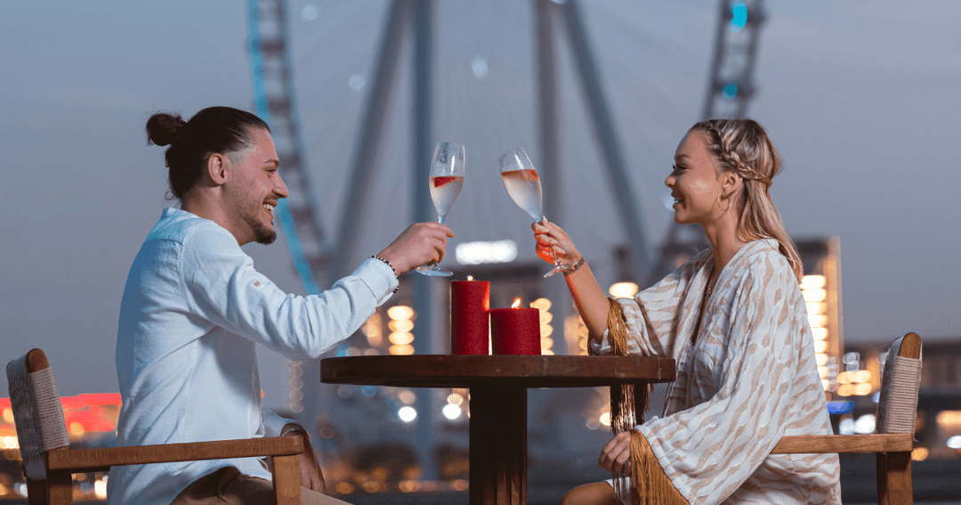 A couple toasting their drinks