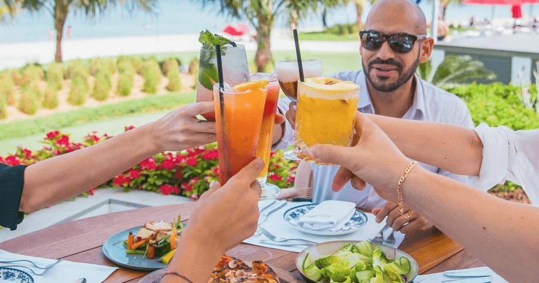 People toasting their drinks at a brunch