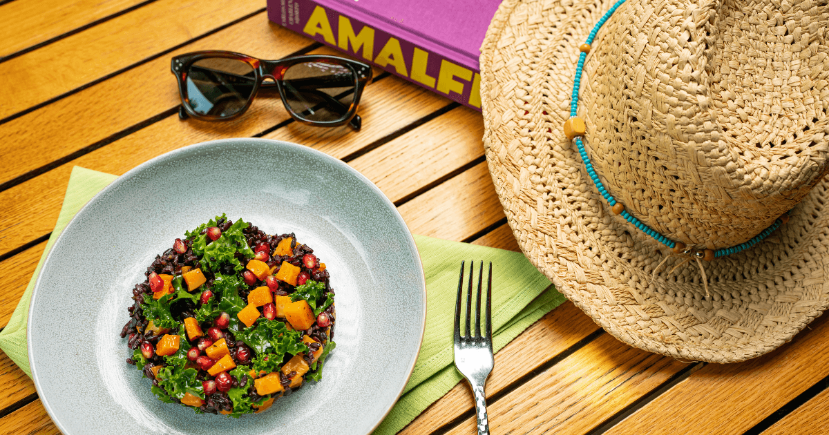 Straw hat, sunglasses and food on a table