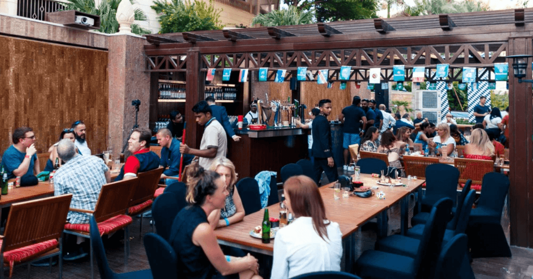 Guests eating and drinking in the outdoor area at Double Decker