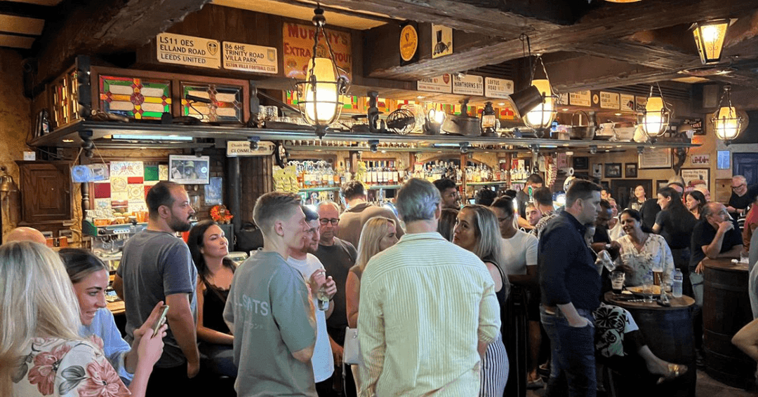 Guests enjoying food and drinks by the bar