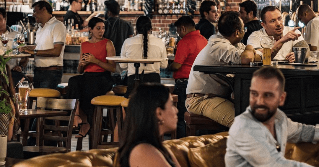 Guests enjoying food and drinks at The Black Sheep