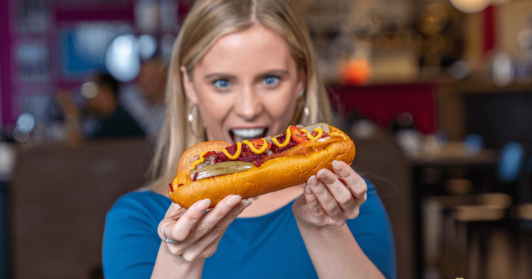 Woman holding a philly steak sandwich