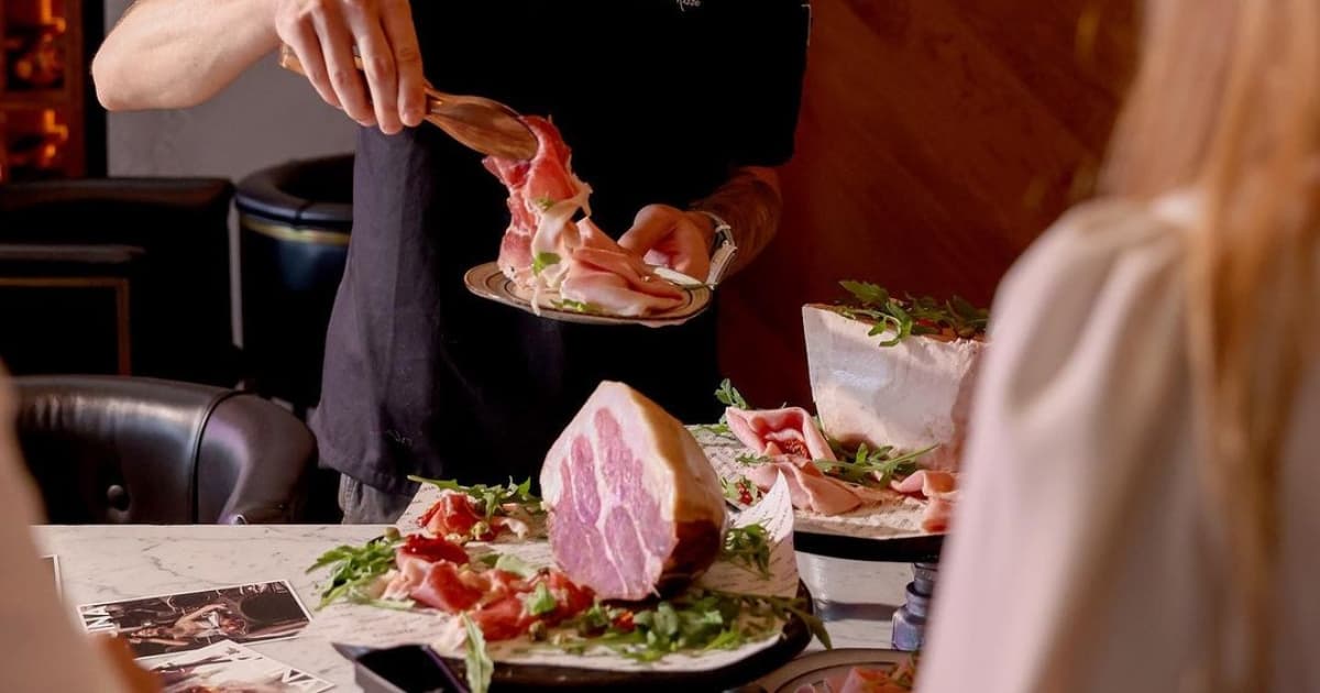 Waiter serving food to someone at a table