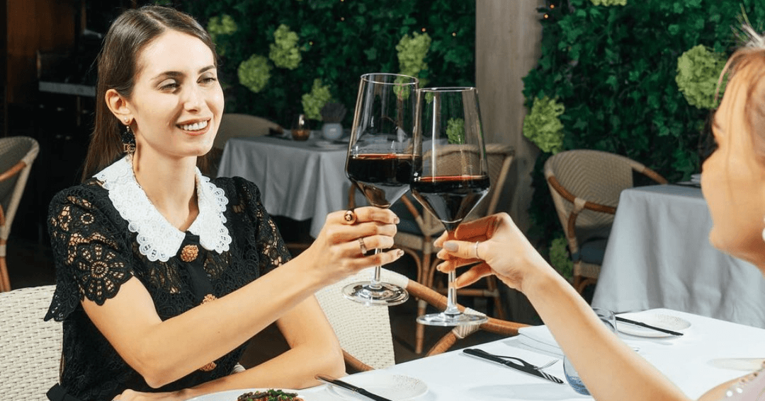 two ladies drinking wine at a restaurant