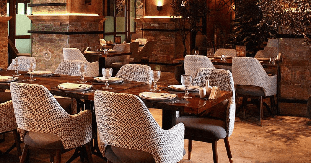 tables and chairs at empty restaurant