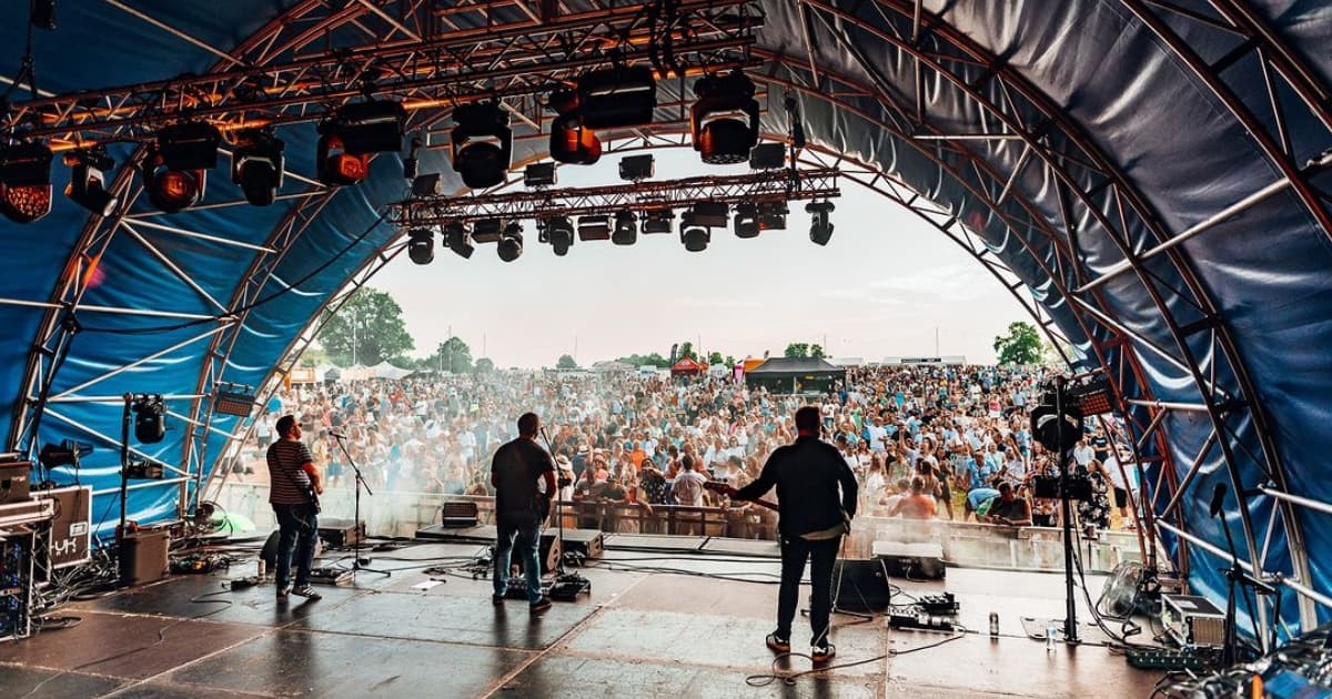 Band playing on a stage with fans in the crowd