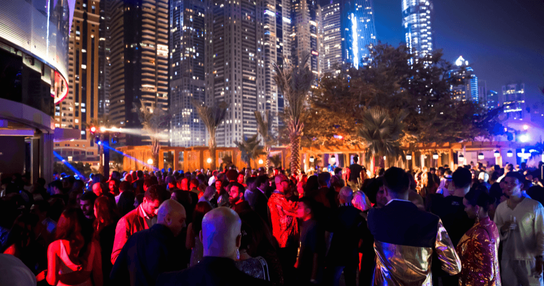 people partying at night with dubai skyline view