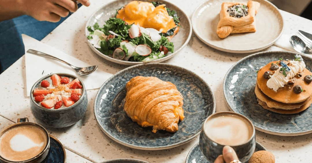 Delectable breakfast spread at Aqaya, Dubai Creek Harbour, featuring fresh pastries and vibrant salads.