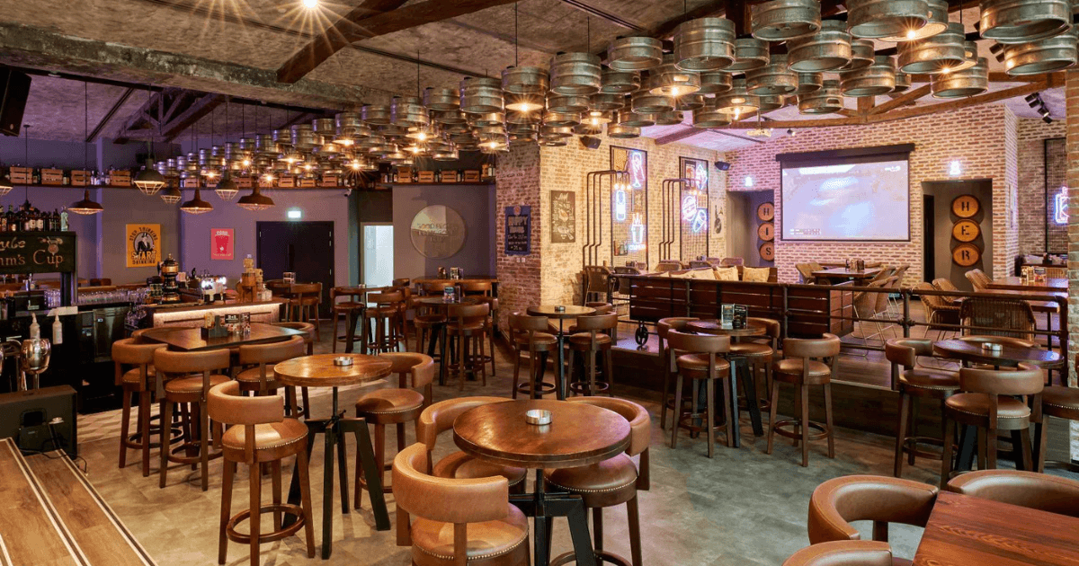 Stylish interior of Brew House in Dubai featuring industrial decor and ample seating.