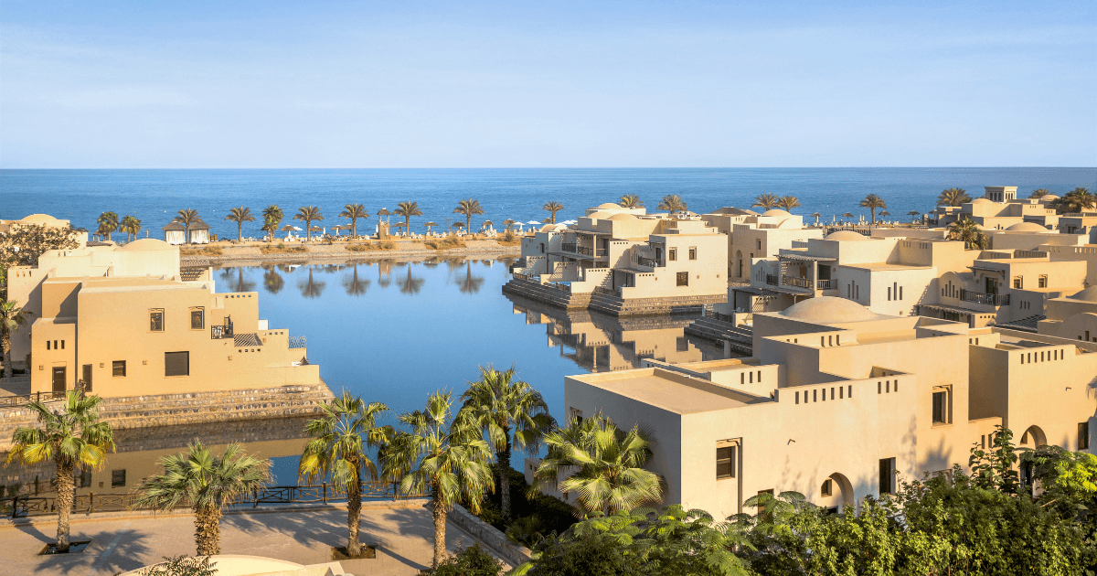 Panoramic view of The Cove Rotana Resort in Ras Al Khaimah, highlighting the luxurious villas and the expansive beach area.