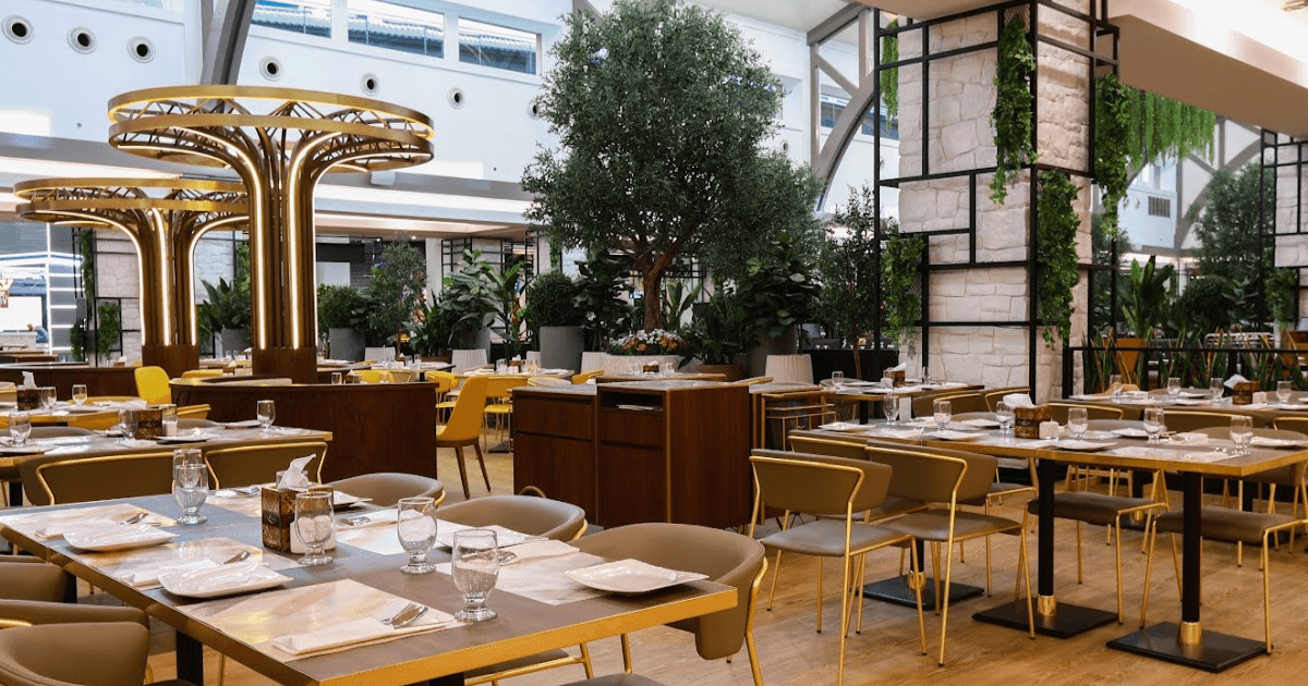 "Elegant dining area at Gazebo, Mall of the Emirates, with modern decor and greenery."