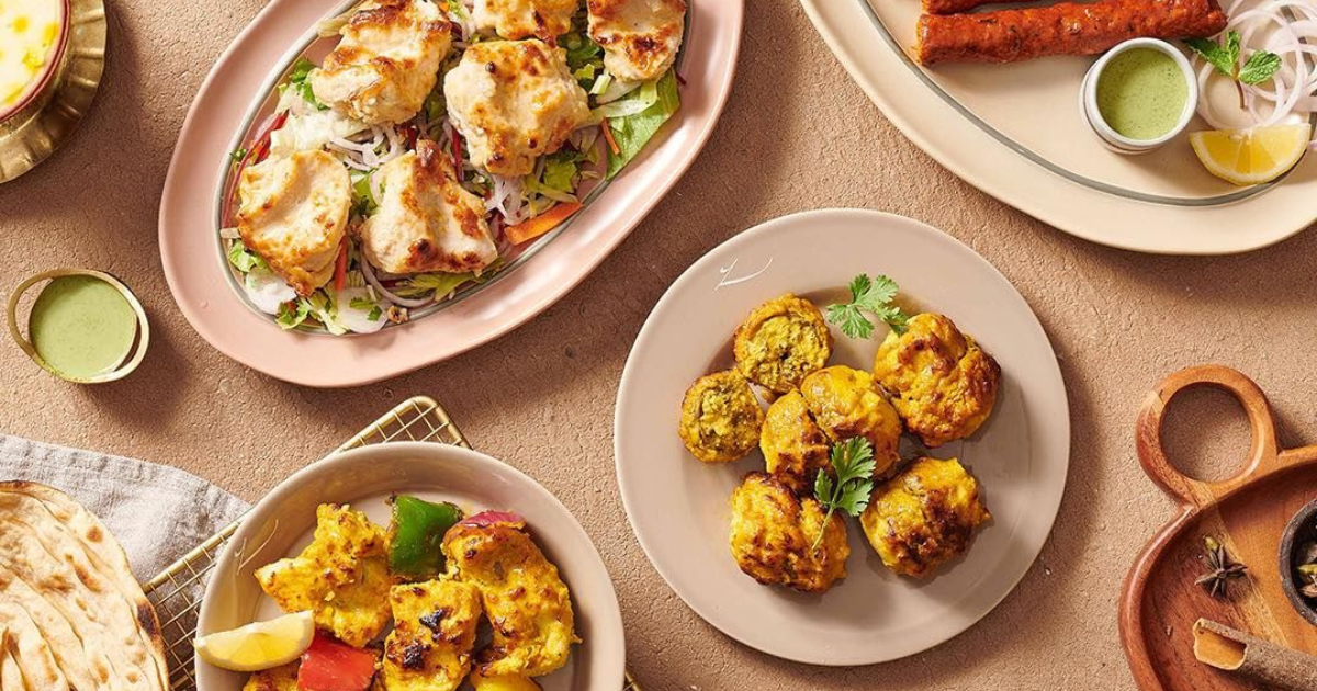 Vibrant Indian dishes at Gazebo, Mall of the Emirates, featuring grilled chicken and kebabs