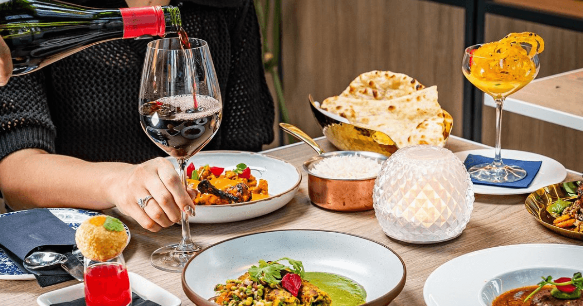 Elegant dining experience with wine and gourmet dishes at Gup & Shup, Expo City Dubai.