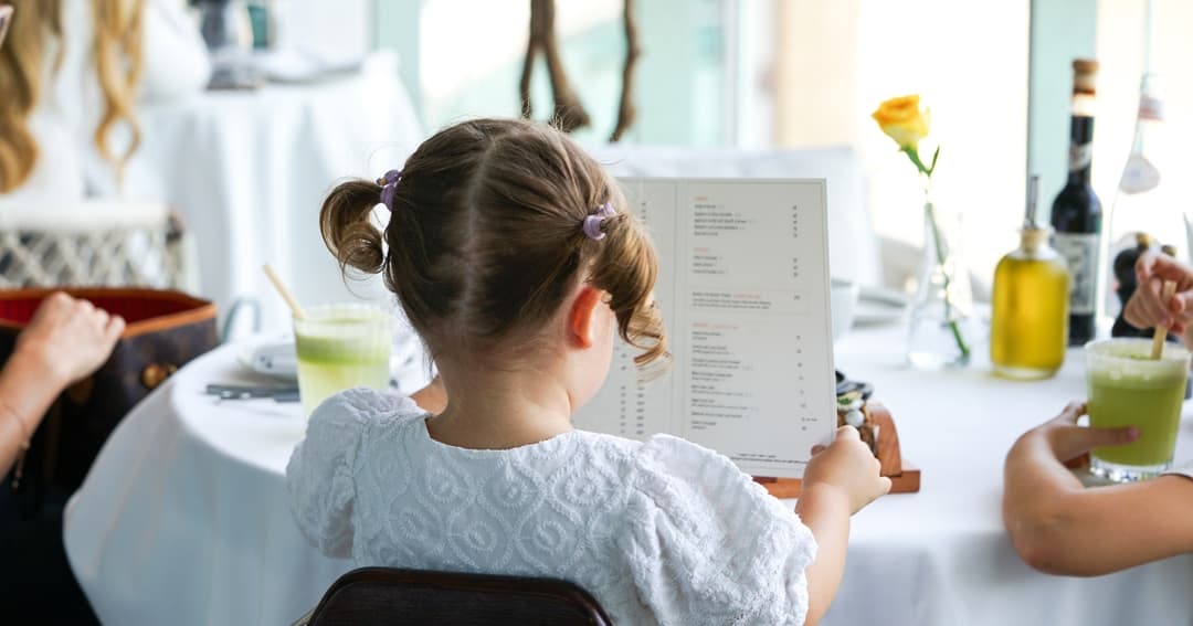 Child reading a food menu