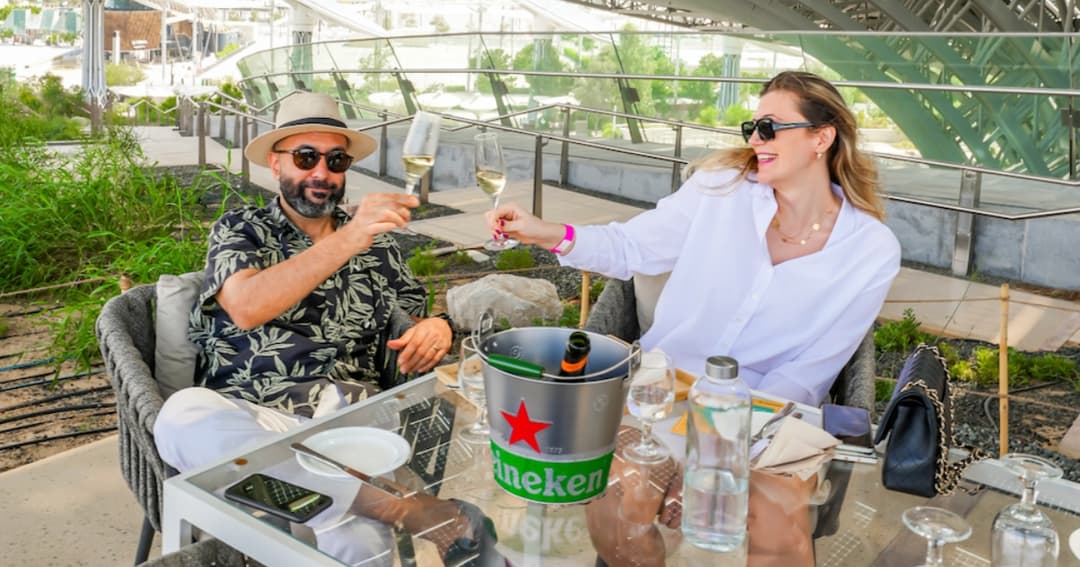 Two people drinking on a rooftop