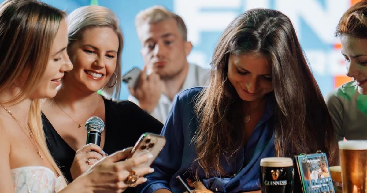 Three ladies looking at a phone screen