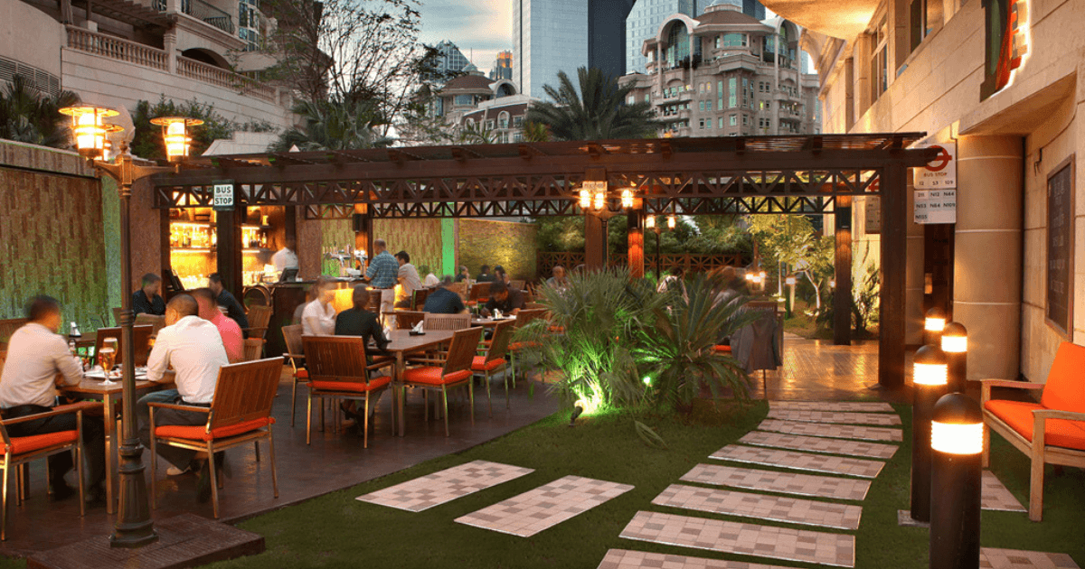 Outdoor seating area at The Underground Pub in Dubai with patrons enjoying their meals.