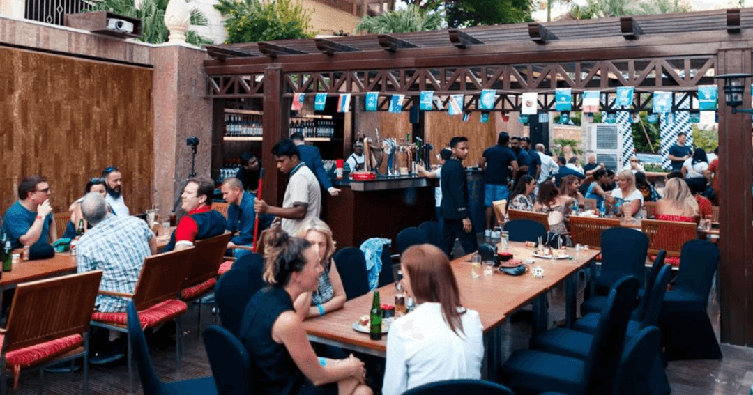 Guests socializing and dining at The Underground Pub in Dubai during a lively event.