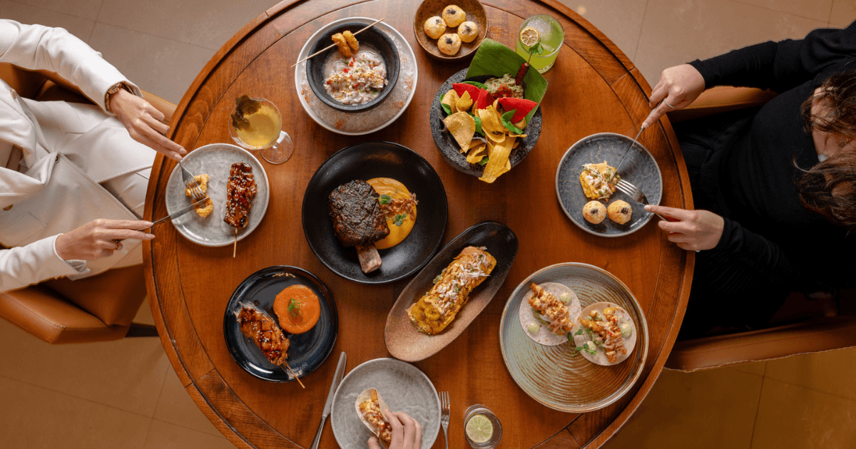 A top-down view of a dining experience at ZOCO Dubai, featuring a variety of beautifully plated dishes perfect for sharing.